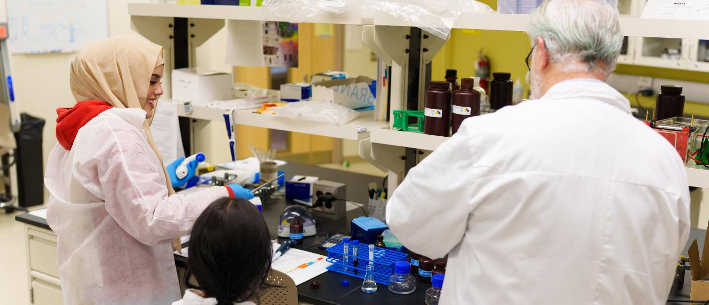 Three people working together in a lab.