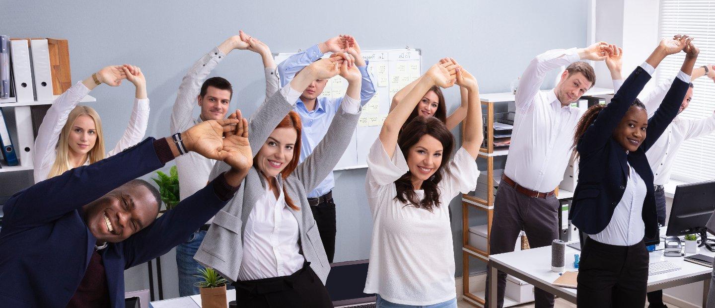 Staff in a corporate office performing a side bend stretch.